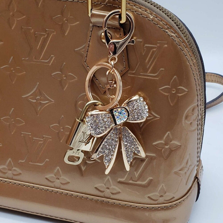 GORGEOUS on sale Gold Tone Louis Vuitton S-Lock Hardware with FREE Bag Charm.